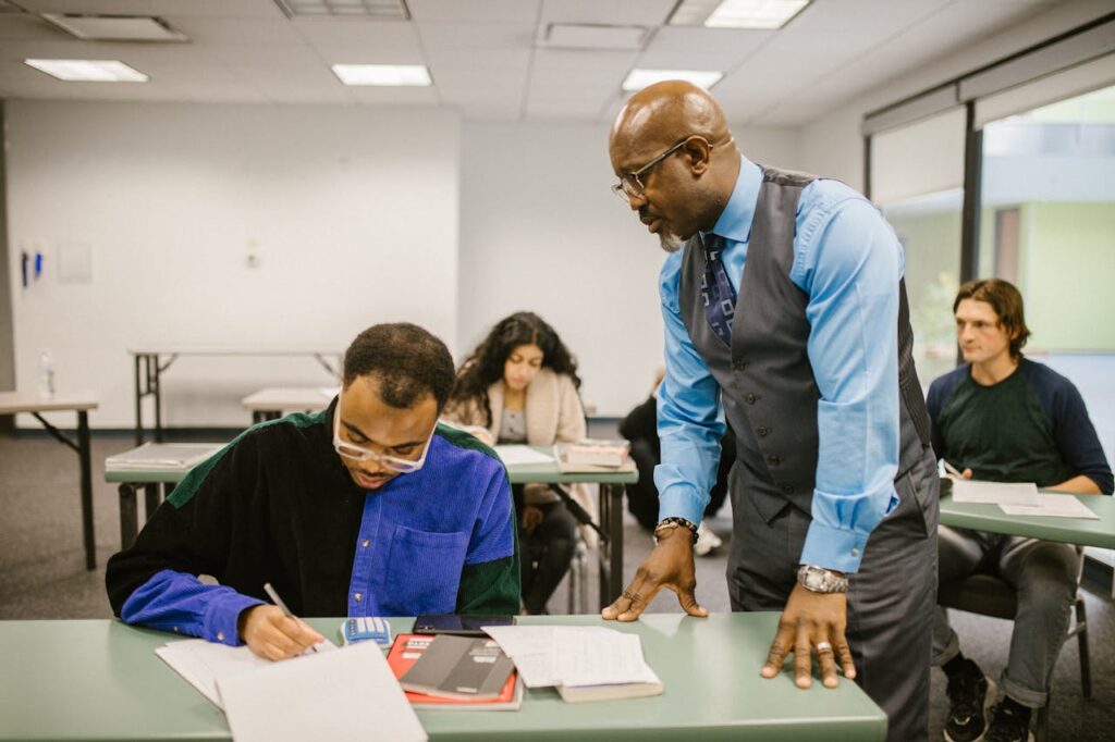 Teacher Proctoring His Students During an Examination